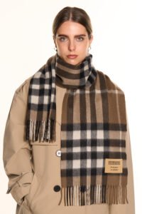 Classic tartan and solid scarves displayed to show heritage craftsmanship