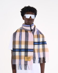 A folded navy tartan cashmere scarf.