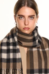 A styled gift display of cashmere scarves in boxes with ribbons, symbolising luxury and thoughtful gifting.