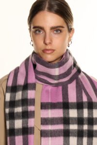 Close-up of hands presenting a neatly wrapped Lucchi Italy scarf in a heritage-inspired gift box.